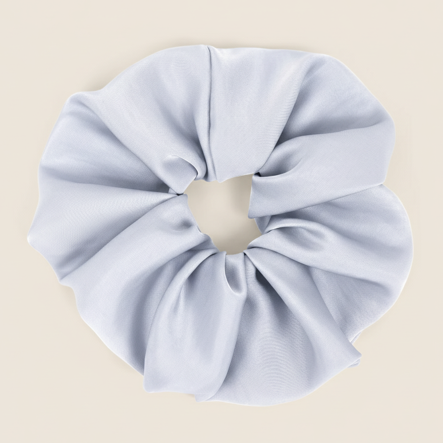 Light blue scrunchie on a beige background